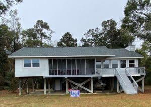 Roofers installing a new roof on a residential home in Monticello, Florida.