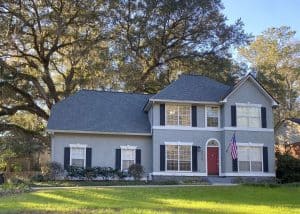 Roofers installing new roof on a large residential home in Monticello, FL.