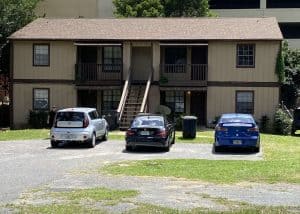 Roofers inspecting residential building roof in Tallahassee, FL.