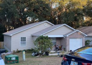 Roofers installing new roof on residential home in Monticello, FL.