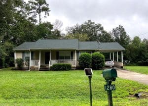 Roofers inspecting a residential roof for maintenance and storm damage in Tallahassee, Florida.