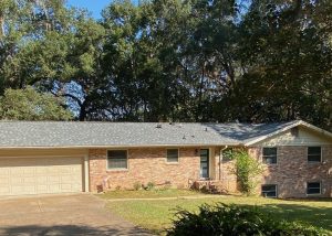 Roofers installing new roof on residential home in Tallahassee, FL.