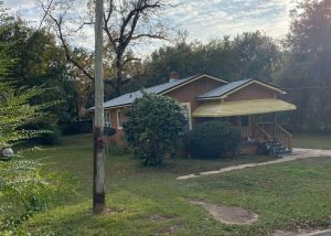 Roofers installing new roof on residential home in Tallahassee, Florida.