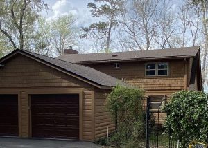 Roofers inspecting a residential roof for storm damage in Tallahassee, Florida.
