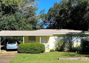 Roof replacement crew installing new roofing on a residential home in Crawfordville, Florida.
