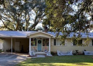 Roofers installing new roof on residential home in Tallahassee, FL.