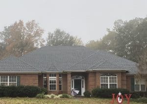 Roof replacement crew installing new shingles on a residential home in Monticello, Florida.