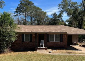 Roofers installing new roof on a brick house in Monticello, Florida.