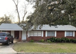 Roof replacement crew inspecting a residential roof in Monticello, FL.