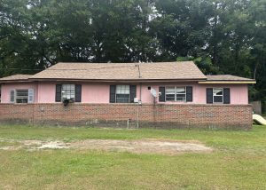 Roofers installing new roof on a residential home in Tallahassee, FL.