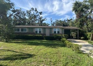 Roofers inspecting a residential roof for replacement in Monticello, FL.