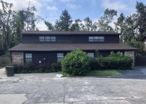 Roofers installing new roof on residential building in Crawfordville Florida.
