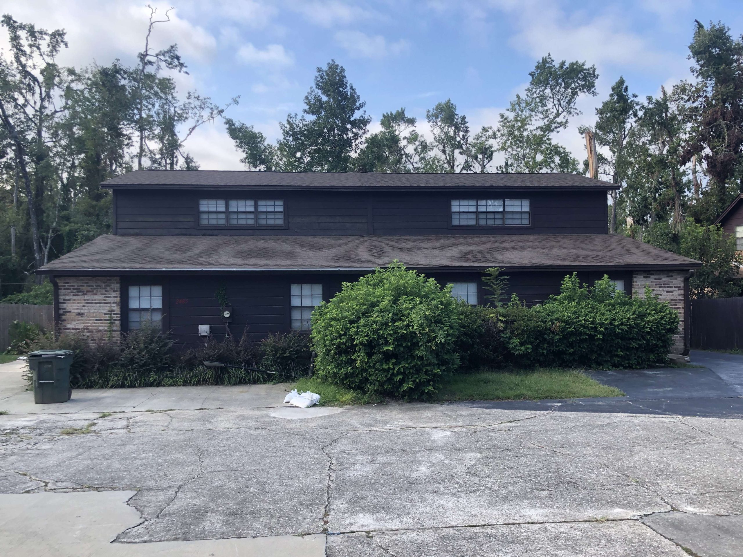 A house with trees in the background.