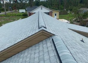 New asphalt shingle roof installed on residential home after storm damage.