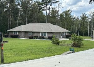 Roofers installing new roof on residential home in Monticello, FL.