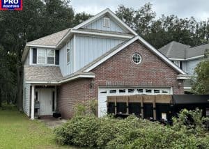 Roofers installing new roofing on a residential home with storm damage repair.