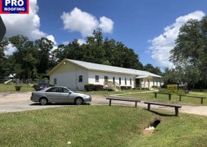 Roofers installing new roof on residential building in Monticello, FL.