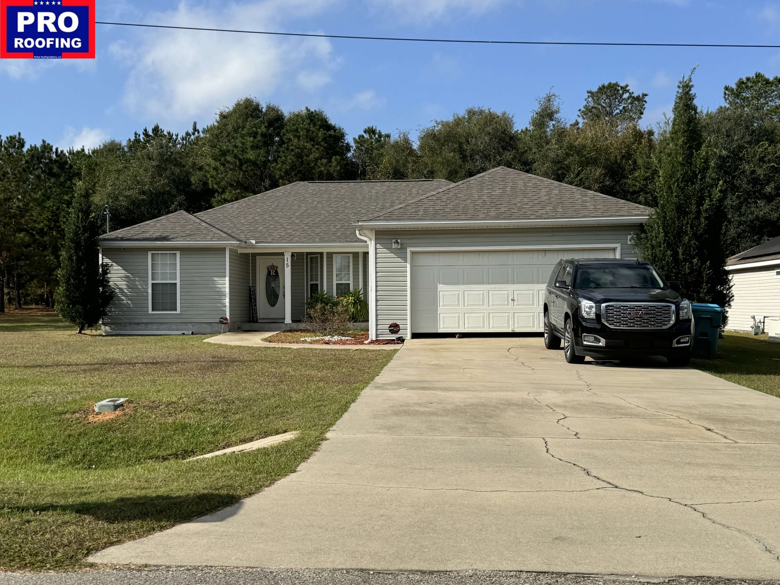 Single-story house with a two-car garage and a black SUV parked in the driveway; Pro Roofing logo appears in the upper-left corner.